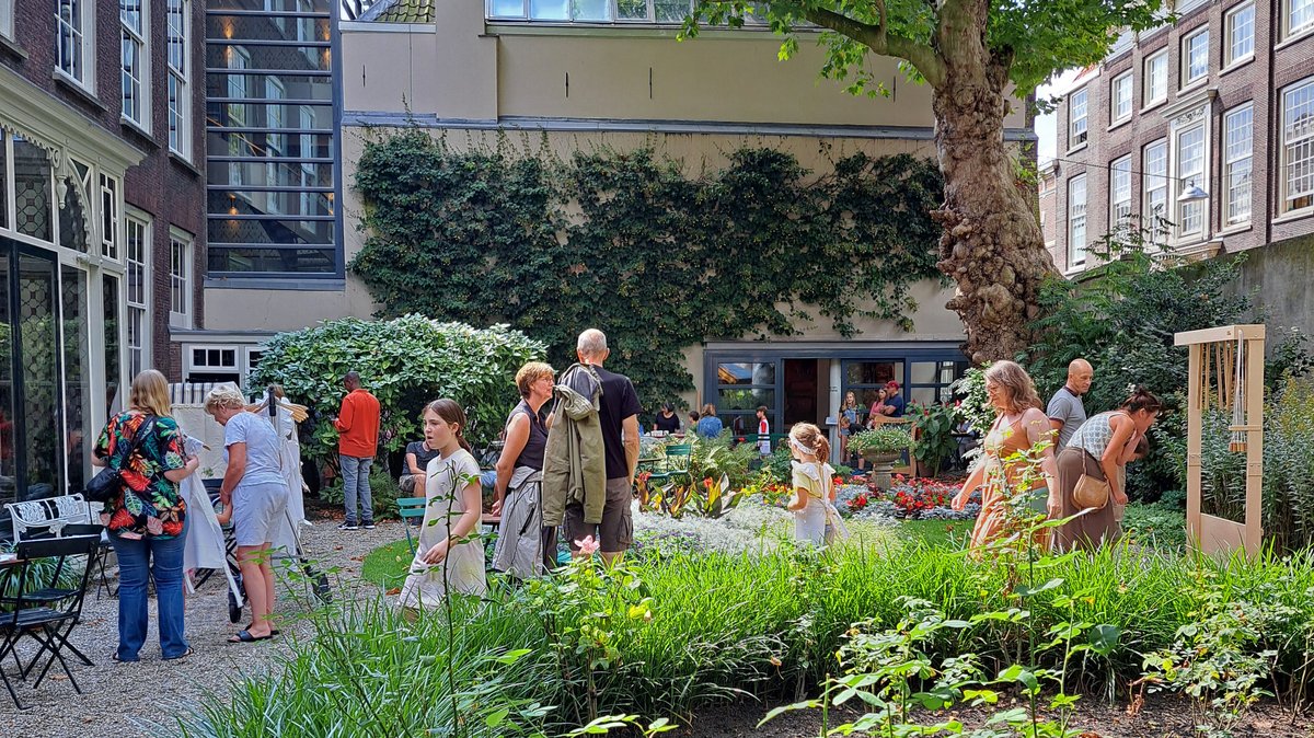 Op de foto zijn diverse ouders en kinderen in de spelletjes aan het doen in museumtuin van Huis Van Gijn, tijdens het buitenspelen evenement.